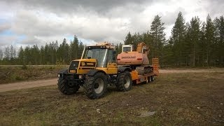 Pulling Samsung excavator with JCB Fastrac 155 [upl. by Nohcim]