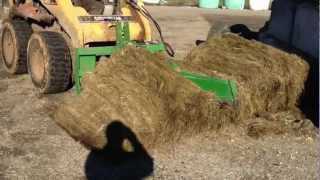 Cutting a round bale in half with Mchale Bale Knive amp Caterpillar 262B SkidSteer [upl. by Landy860]