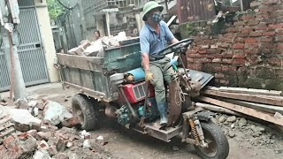 Small excavator scoops bricks onto threewheeled vehicle [upl. by Treulich]