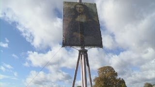 Giant Mona Lisa portrait Canvas standing 14 metres tall installed on Clapham Common [upl. by Nochur392]