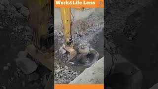 An excavator loads rocks into a vibrating cone crusher breaking them down for construction use [upl. by Girhiny487]