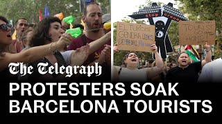 Antitourism protesters soak diners with water pistols in Barcelona [upl. by Rheta654]