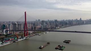 SHANGHAIYangpu District Aerial shot over Huangpu River with Yangpu Bridge and Shanghai skyline [upl. by Nwaf]