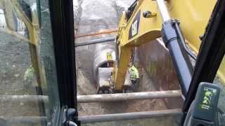 Cat 330d digging and laying 60quot concrete drain pipe [upl. by Aidualc]