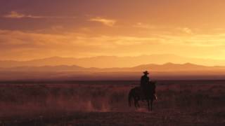 Slow motion shot of a cowboy riding a horse [upl. by Reiss36]