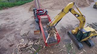 Morbark 6400XT Horizontal Grinder Processing Pallets Stumps and Yard Waste [upl. by Ahsineg]