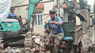 Compact excavator scoops soil onto threewheeled cart [upl. by Lafleur]