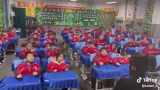 Chinese school children exercising at their desks [upl. by Simeon]