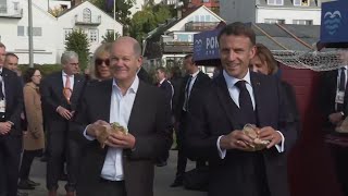 German chancellor and French president tuck into fish sandwiches in Hamburg [upl. by Powe526]