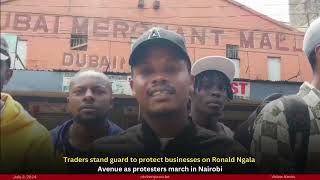 Traders stand guard to protect businesses on Ronald Ngala Avenue as protesters march in Nairobi [upl. by Eves]