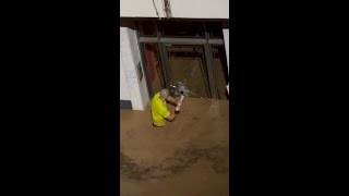 Man smashes glass door to save children in Spanish floods [upl. by Pulling711]