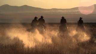 Slow motion dusk shot of cowboys riding towards mountains [upl. by Arrahs]