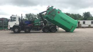 Lifting a Gradeall Hook lift portable compactor [upl. by Ydor235]