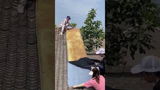 The process of paving self adhesive waterproof fabric on house roof [upl. by Lainad]