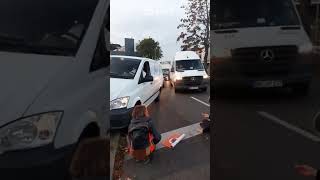 Van nearly hits ecoprotester as it mounts pavement to get past [upl. by Abbotson]